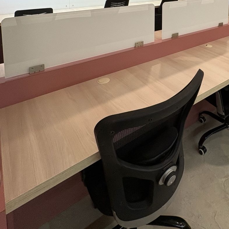 Individual desk setup with monitor and chair